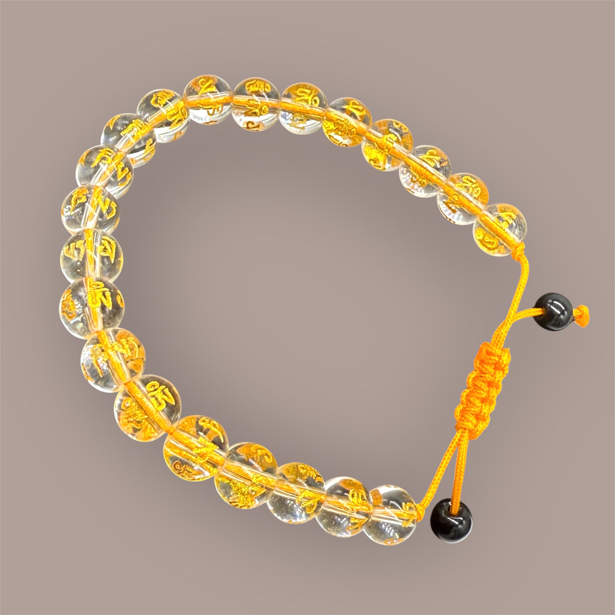 Goldenes Kristall Armband auf beigem Hintergrund