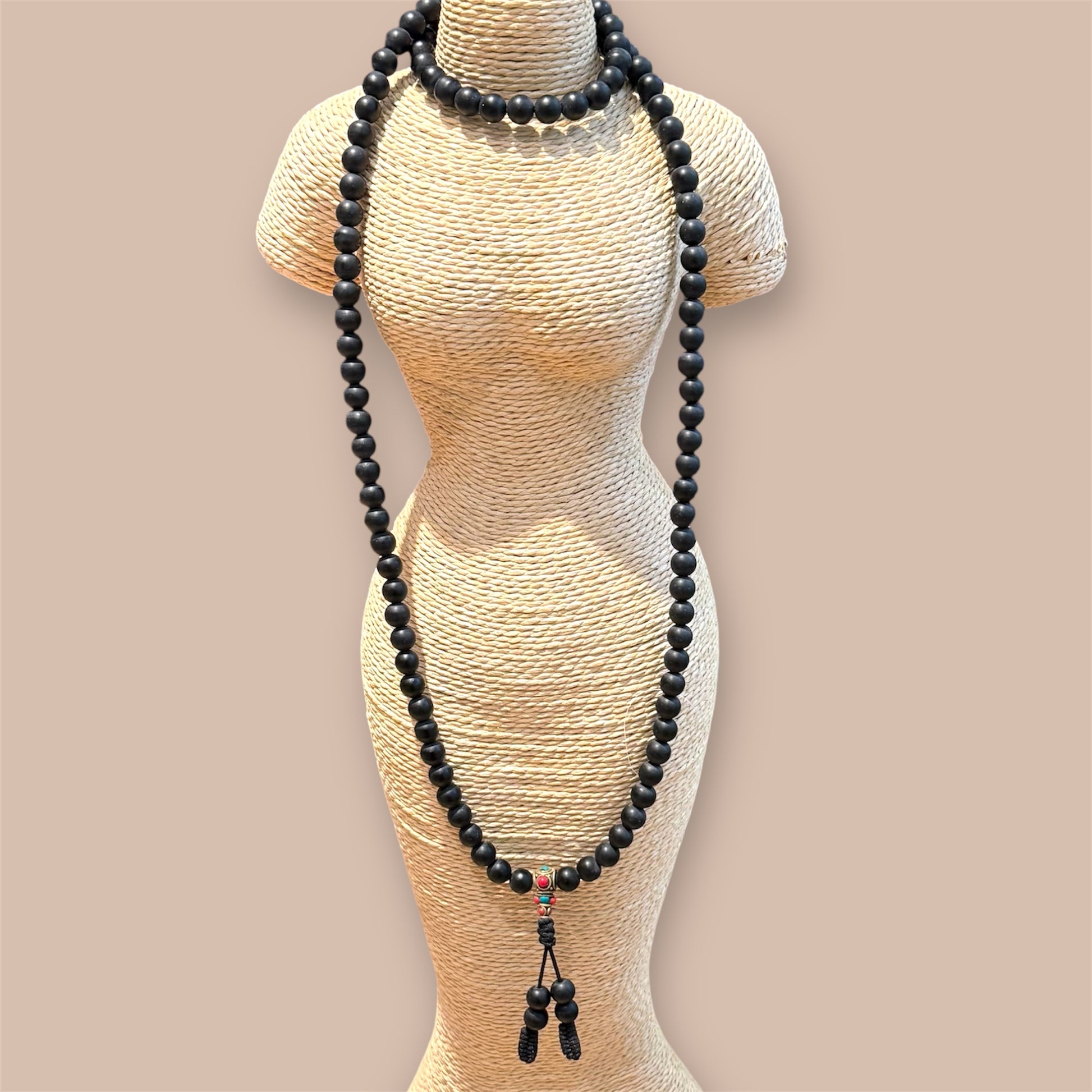 Shaligram 108 Mala, Schwarz auf eine Schmuckpuppe