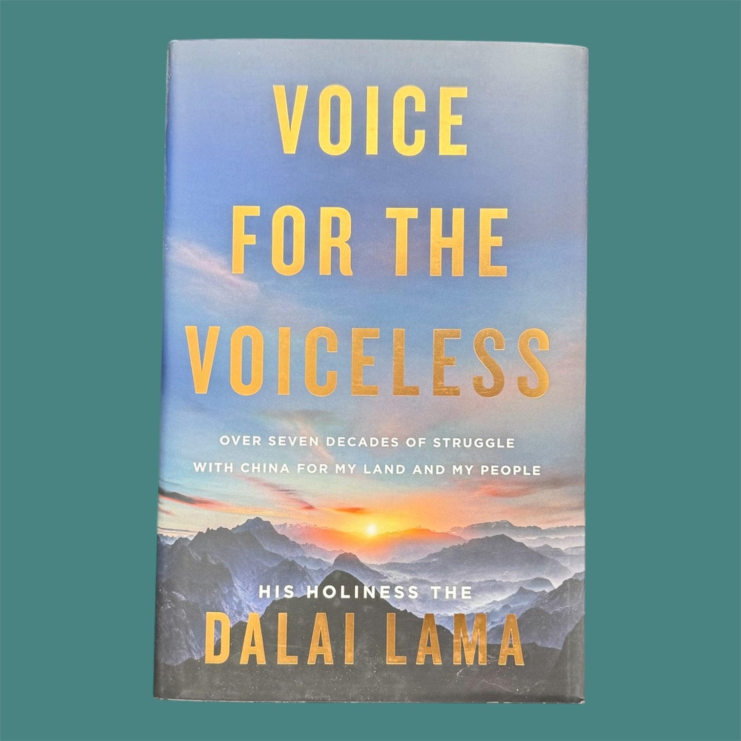 The photo shows a books called the Voice for the Voiceless with a green background.